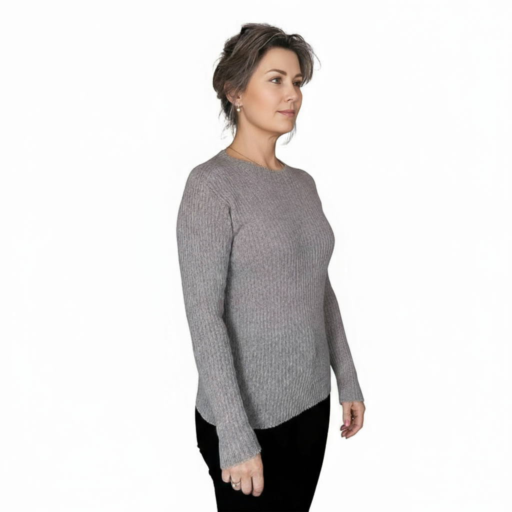 Woman wearing a neutral sand coloured sweater on a white background