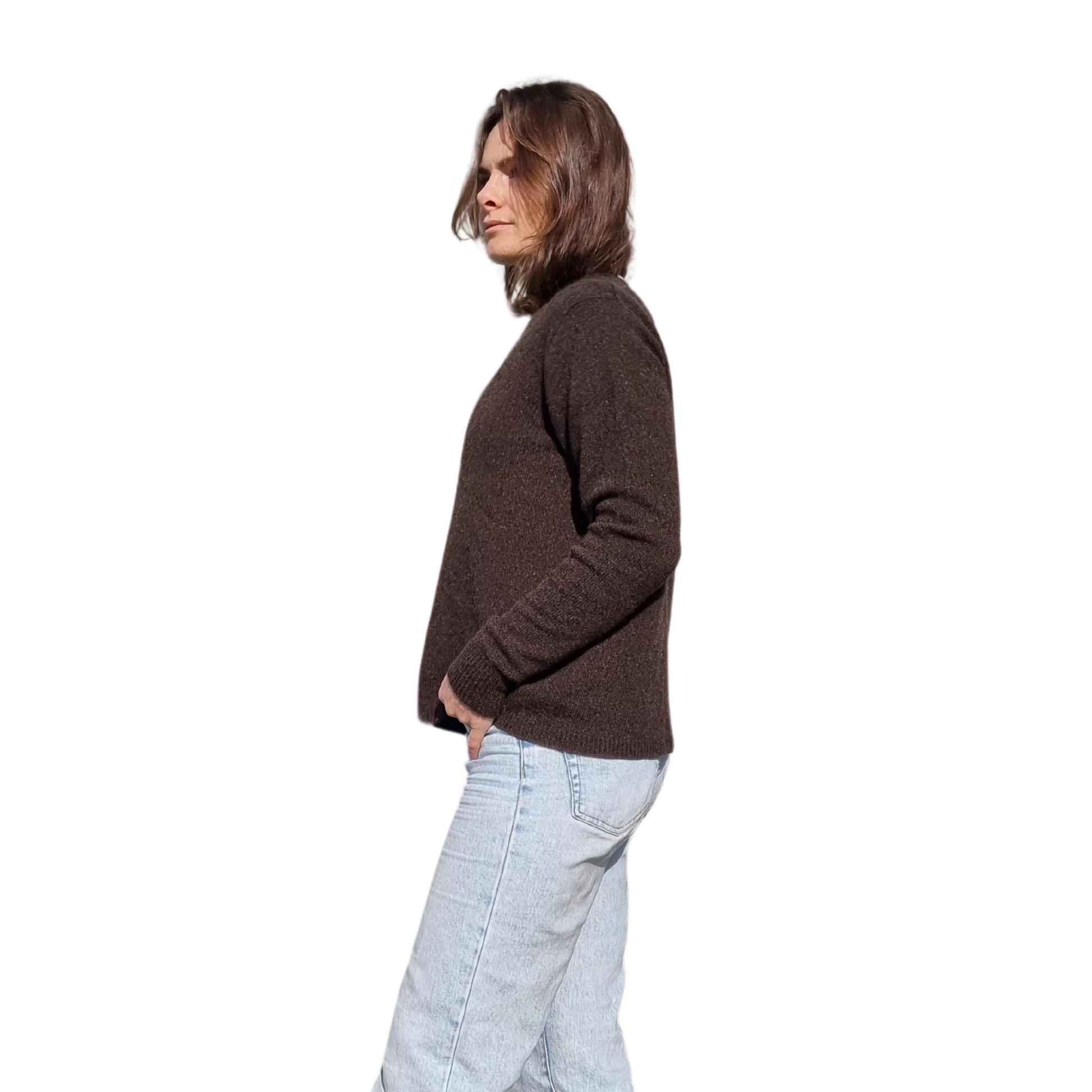 Everyday jumper with a drew neckline and ribbed cuffs and hem in a  kiwi brown colour on a brunette women. The sweater is made locally and ethically in New Zealand by a female designer. Knitwear is made from Merino Possum and silk fiber