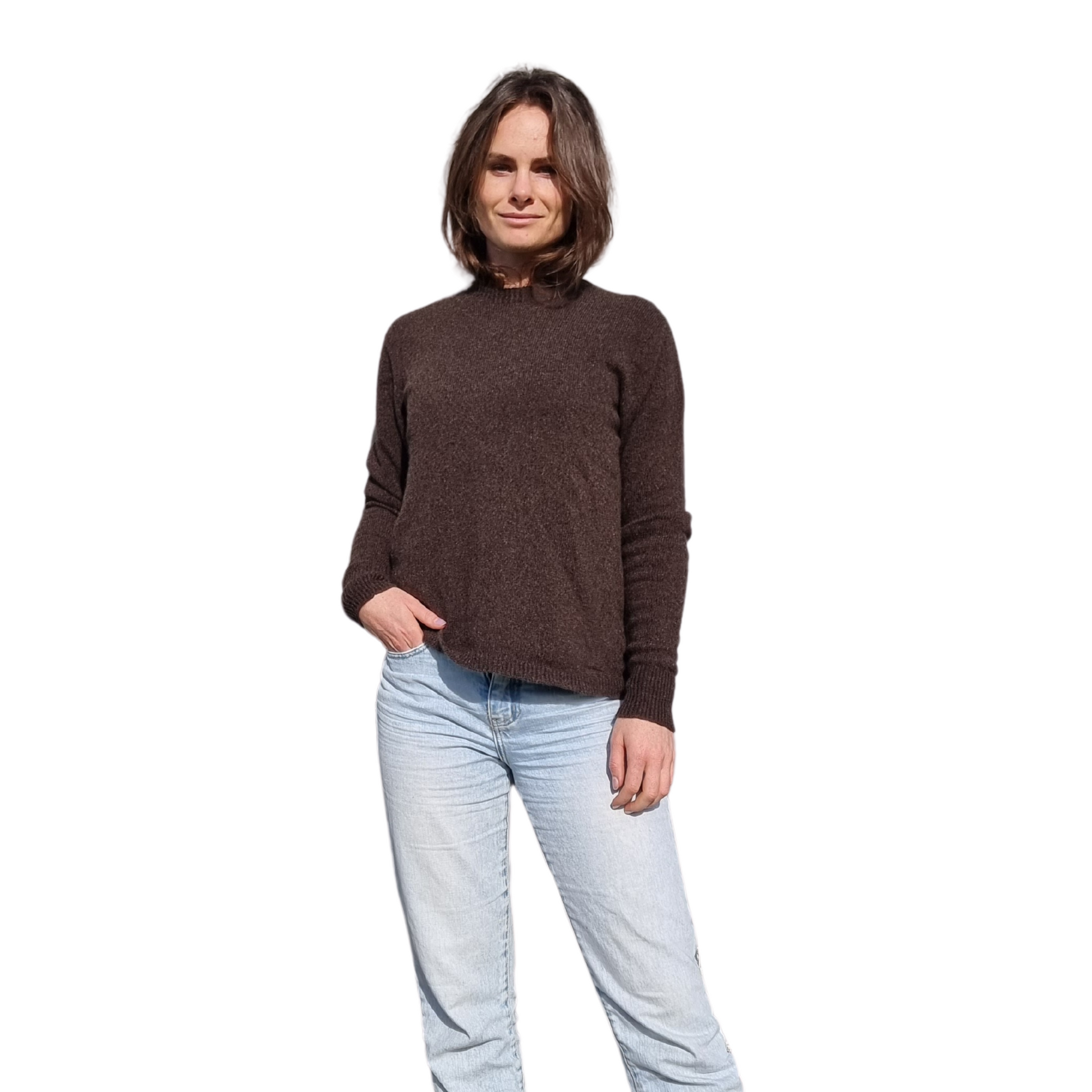 Everyday jumper with a drew neckline and ribbed cuffs and hem in a  kiwi brown colour on a brunette women. The sweater is made locally and ethically in New Zealand by a female designer. Knitwear is made from Merino Possum and silk fiber