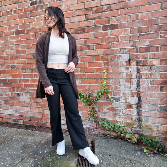 Black haired woman wearing knitted Cardigan in a rich chololate brown colour. Cardi made from Merino Possum and Silk. Knitted locally in New Zealand by an Ethical, sustainable female designer. cardigan has a open front, mid thigh length and long sleeves