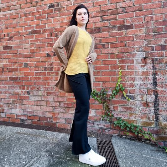 Black haired woman wearing knitted Cardigan in a caramel brown colour. Cardi made from Merino Possum Angora and Silk. Knitted locally in New Zealand by an Ethical, sustainable female designer. cardigan has a open front, mid thigh length and long sleeves