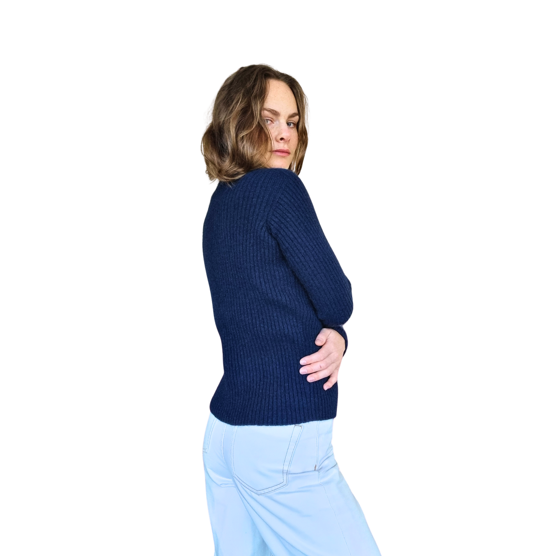 Brunette women wearing a ink blue Merino Possum Nylon Sweater that has a mock neck, long ribbed sleeves and a ribbed body. Jumper is made in New Zealand