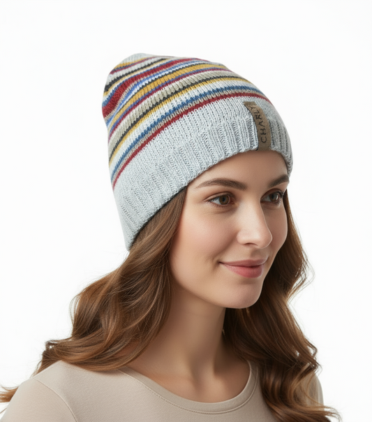 Woman wearing a colorful striped beanie on a white background