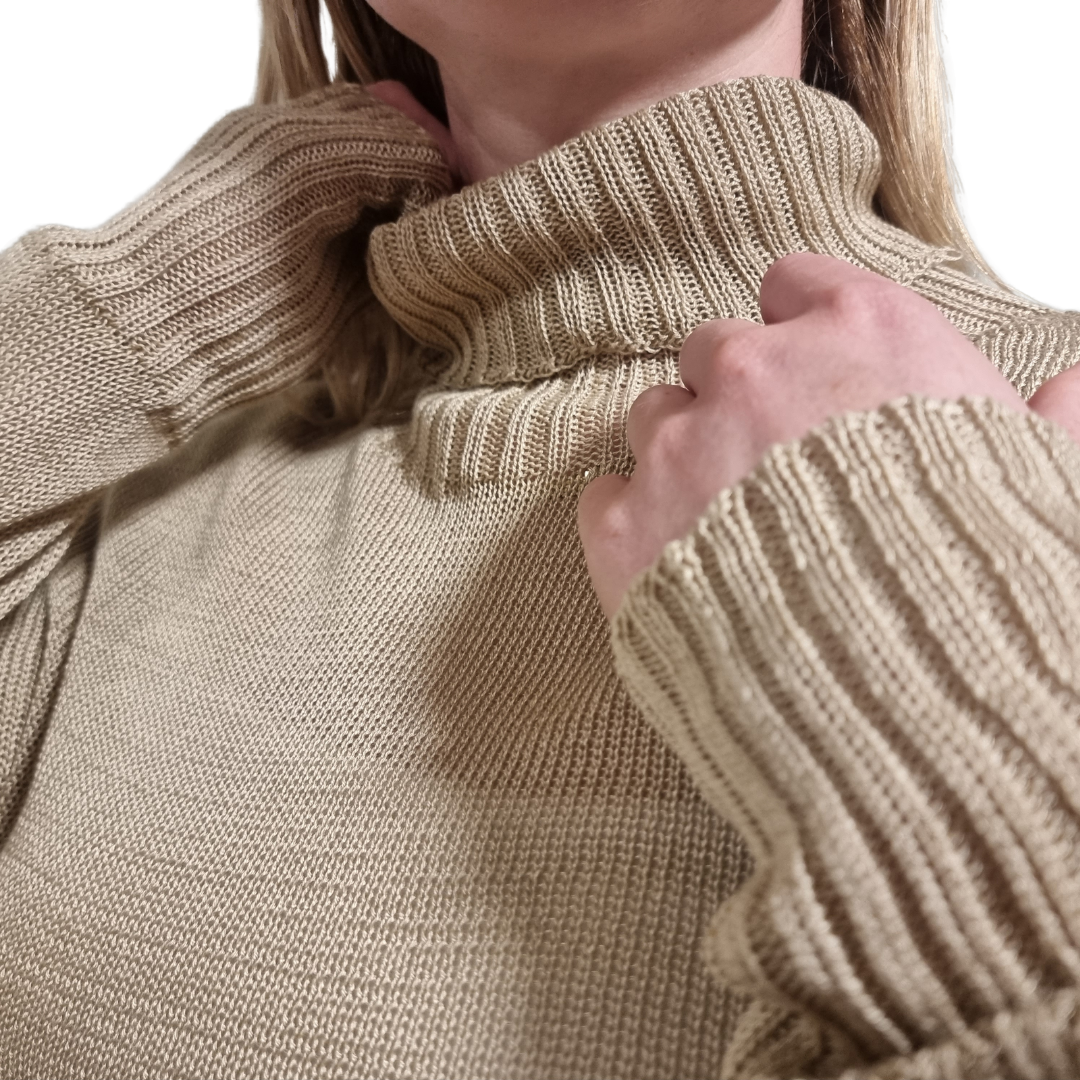 100% Cotton Split hem jumper in a light latte brown colour. Made ethically and consciously in New Zealand. Detail of turtleneck and ribbed cuffs showing.