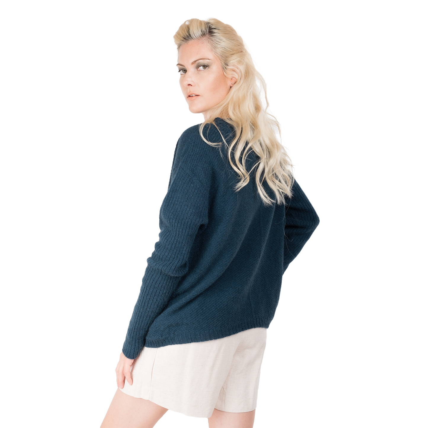 Blonde lady wearing a ocean teal blue cashmere possum silk sweater. It has long ribbed sleeves and rib angled detail knitted on the body. Made in New zealand.