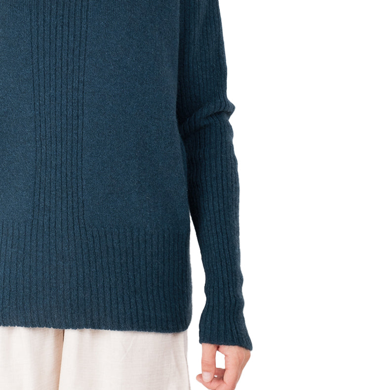 detail view of ribbed hem cashmere possum silk knitted sweater in an ocean teal blue, made in new zealand. Ribbed lined down the cetre front of the sweater and long ribbed sleeves