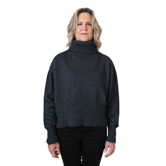 Split Hem Sweater in colour Charcoal. Loose turtleneck. Front