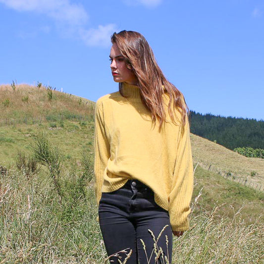 Sports stripe sweater with a turtle neck and long sleeves in a sunshin yellow. Made in NZ from New Zelaand Merino Possum and Silk