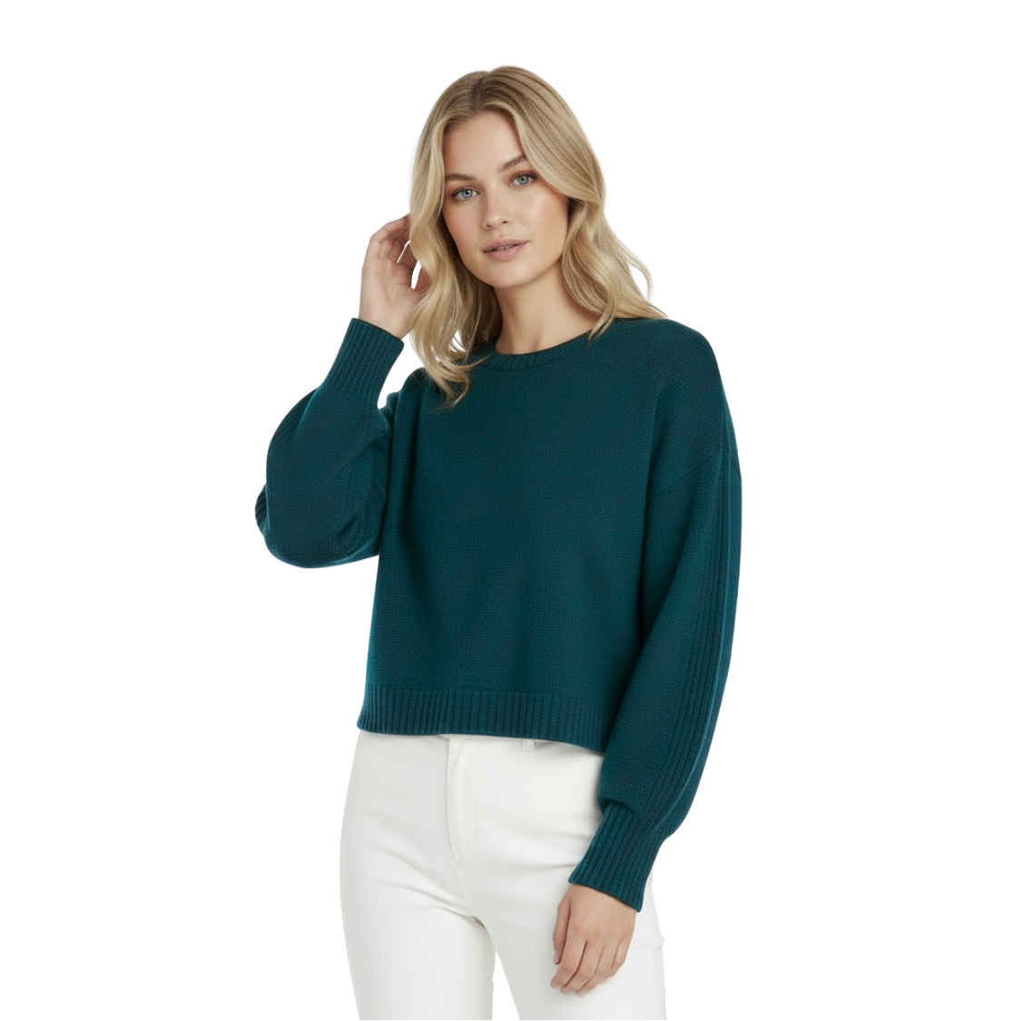 Woman wearing a teal sweater and white pants on a white background