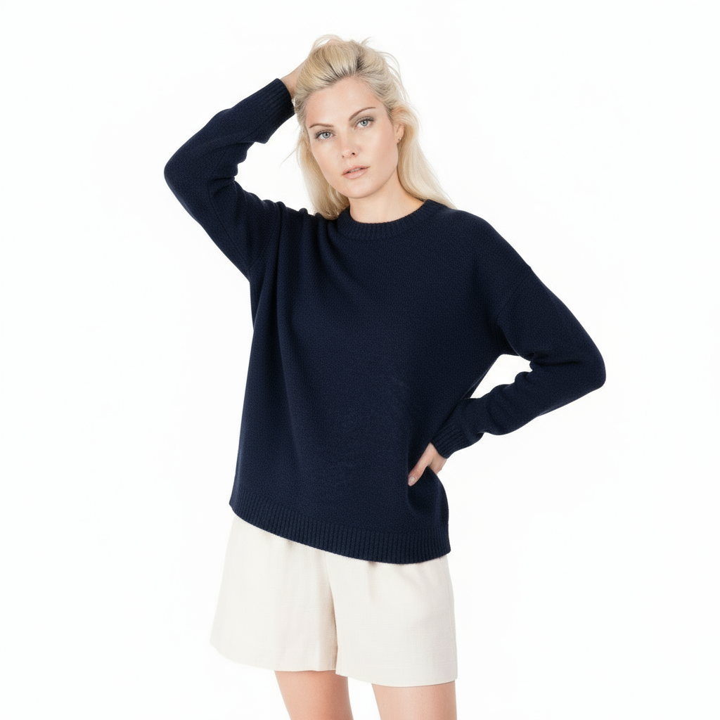 Woman wearing a navy sweater and white shorts on a white background