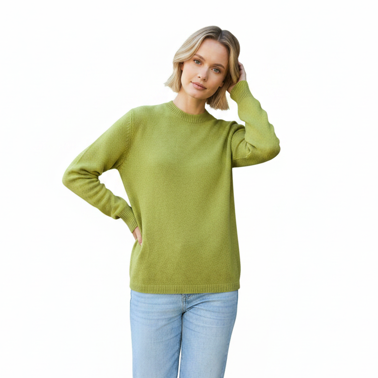 Woman wearing a green sweater and light blue jeans on a white background