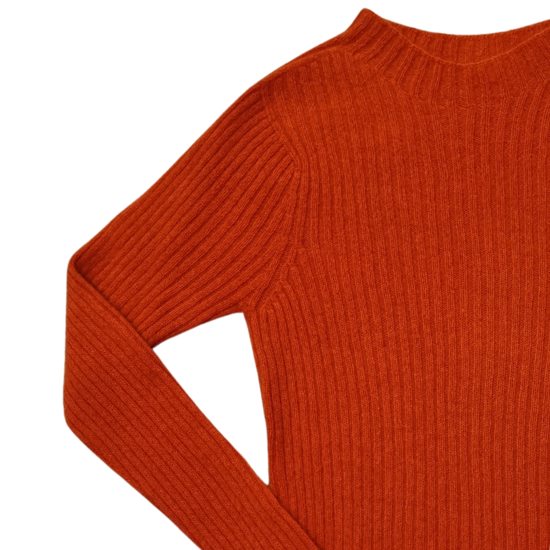 Close-up of an orange ribbed jumper with a built-up crew neck and long sleeves.