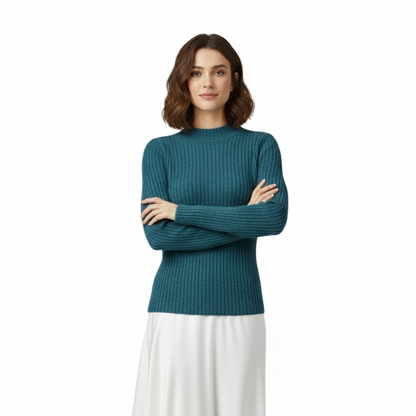 Woman wearing a teal sweater and white skirt on a white background
