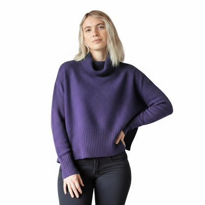 Person wearing a purple sweater on a white background