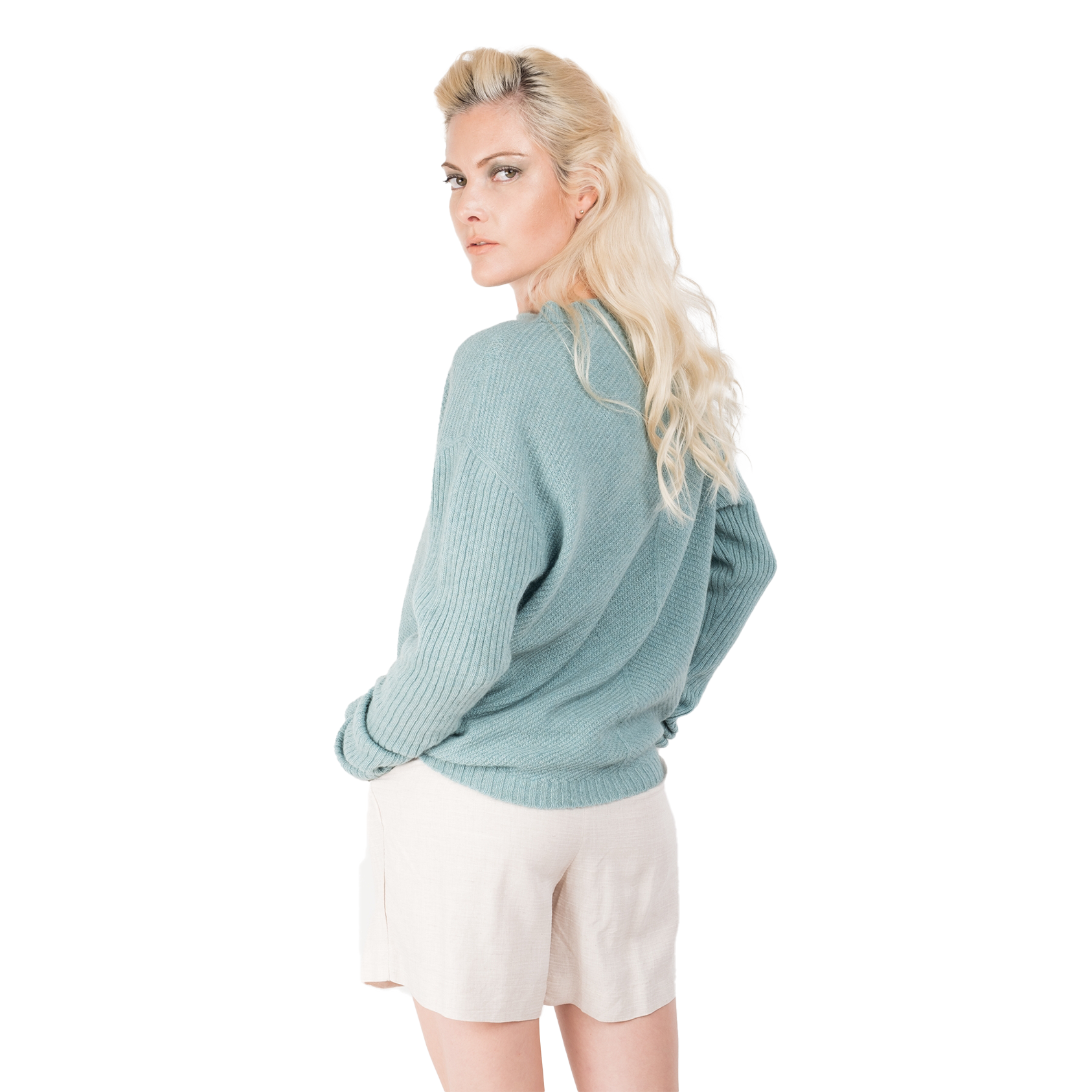 Blonde lady wearing a pale ocean blue cashmere possum silk sweater. It has long ribbed sleeves and rib angled detail knitted on the body. Made in New zealand. 